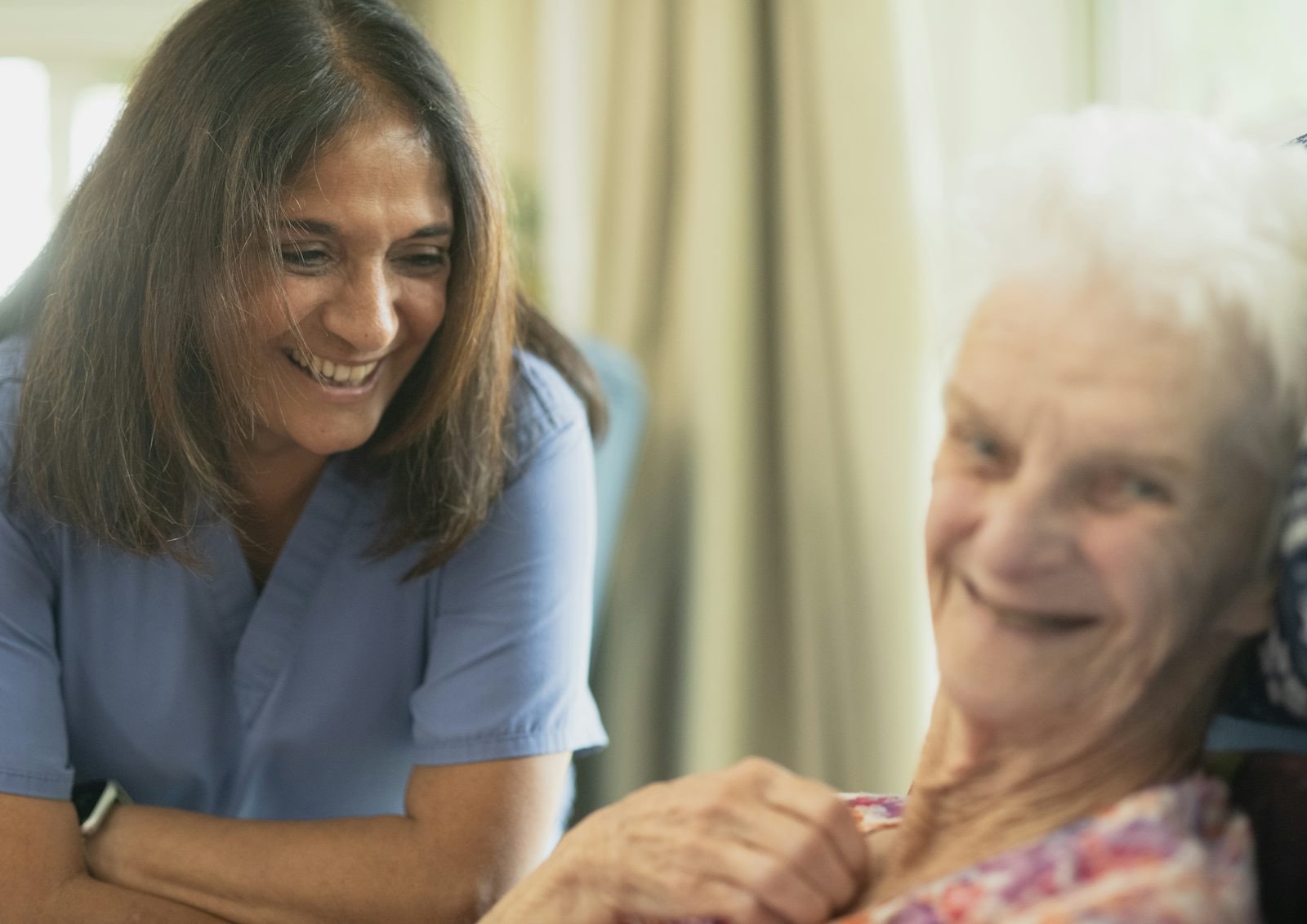 Pflegerin im Gespräch mit einer älteren Patientin